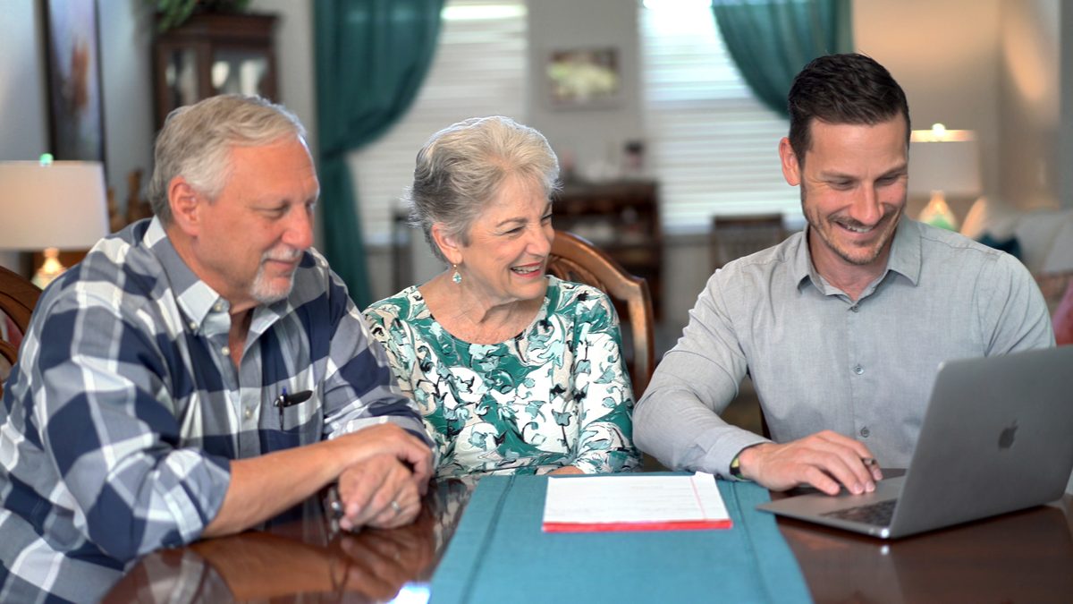 Sean Loomis reviewing retirement options with an FRS couple at their kitchen table